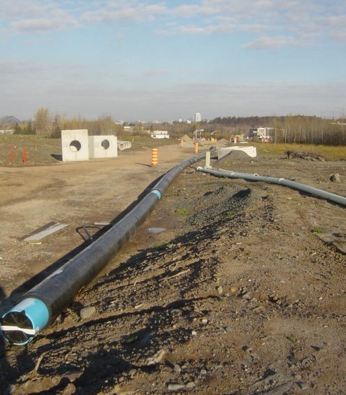 Pre-insulated PVC pipes palced on permafrost.